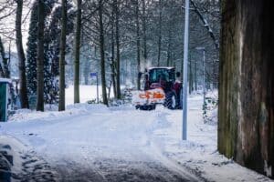 Drive way and road being cleared of snow by a tractor